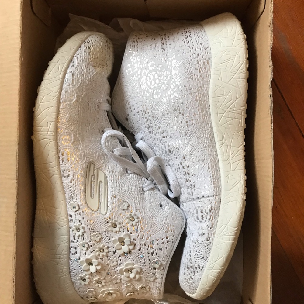 Lace/floral high tops over shimmery white fabric.